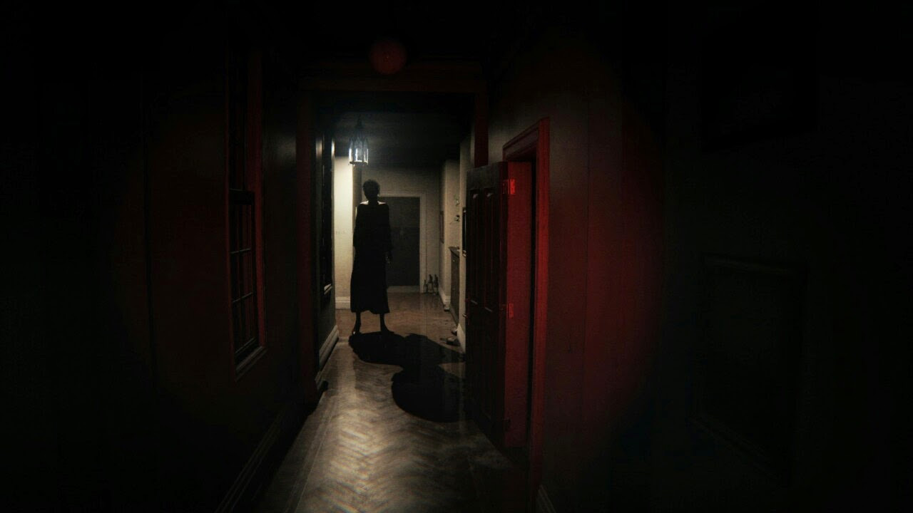 A tall figure stands in shadows at the end of a suburban hallways in Hideo Kojima’s P.T.