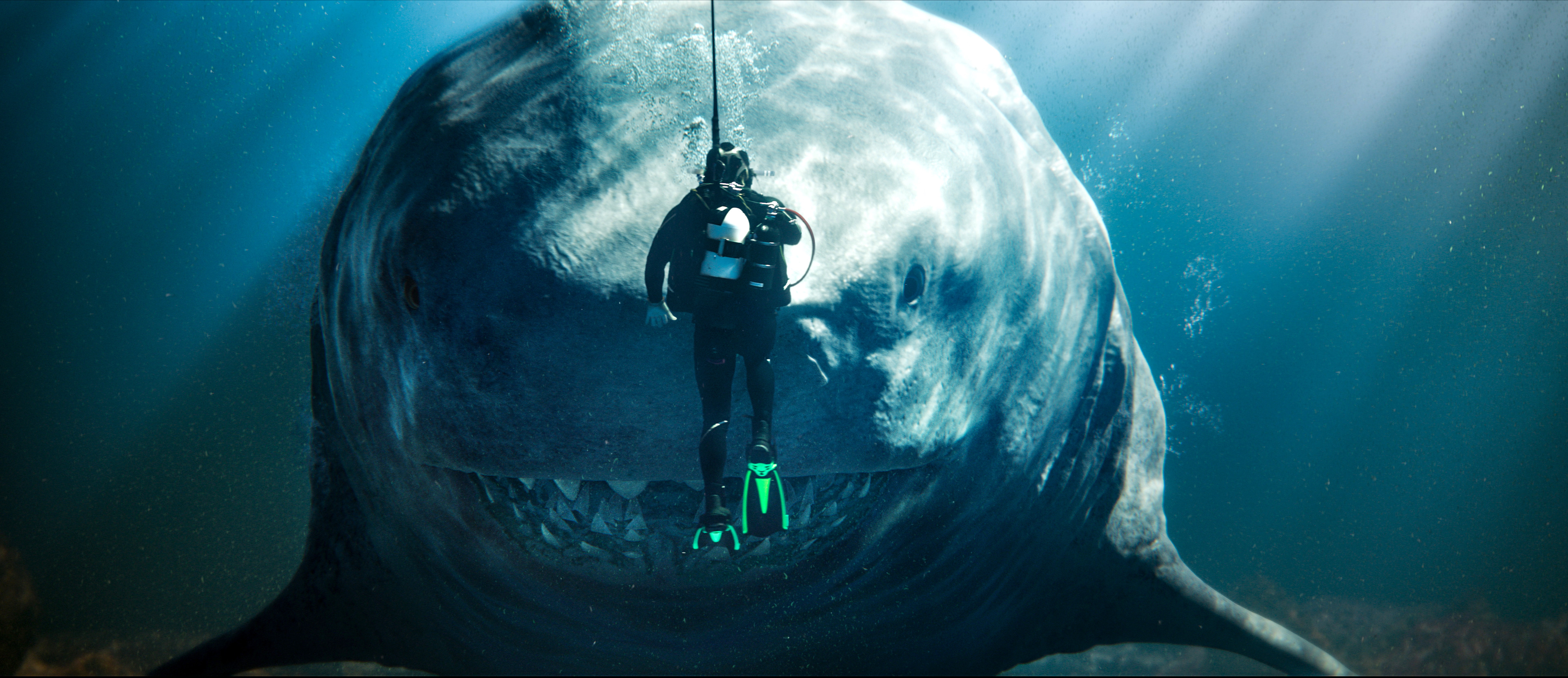 A diver goes face to face with a gigantic megalodon shark in Meg 2: The Trench.