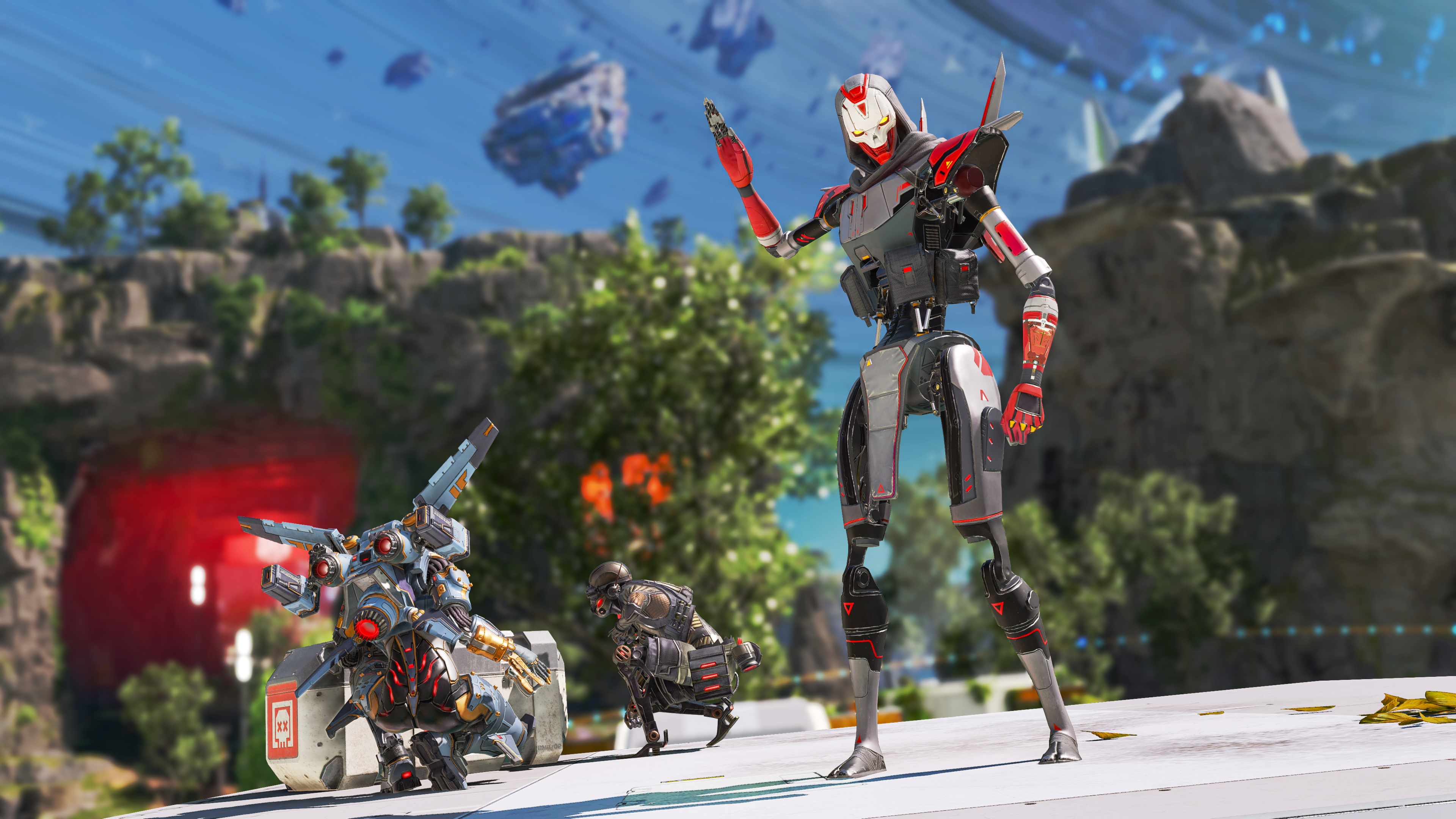 Apex Legends character Revenant raises his right hand while two teammates crouch behind him to open a supply drop